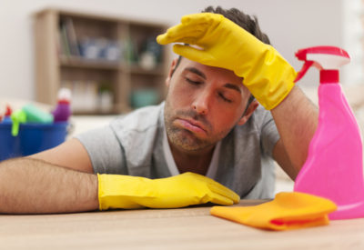 Tired man with cleaning equipment