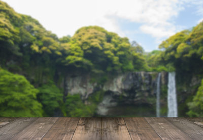 Blurred Cheonjiyeon Waterfall is a waterfall on Jeju Island, South Korea with wooden bridge.