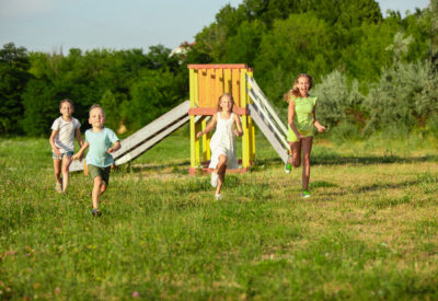 Kids, children running on meadow, summertime